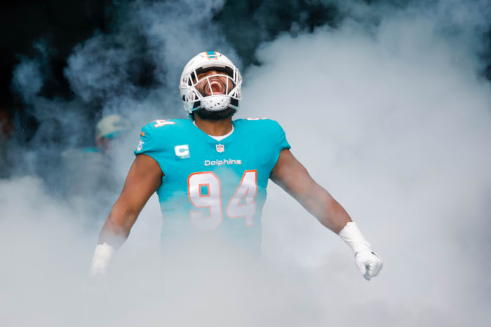 Miami Dolphins defensive tackle Christian Wilkins looks up yelling in celebration as smoky fog comes up around him
